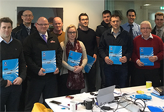 Group of people holding FORS training booklet