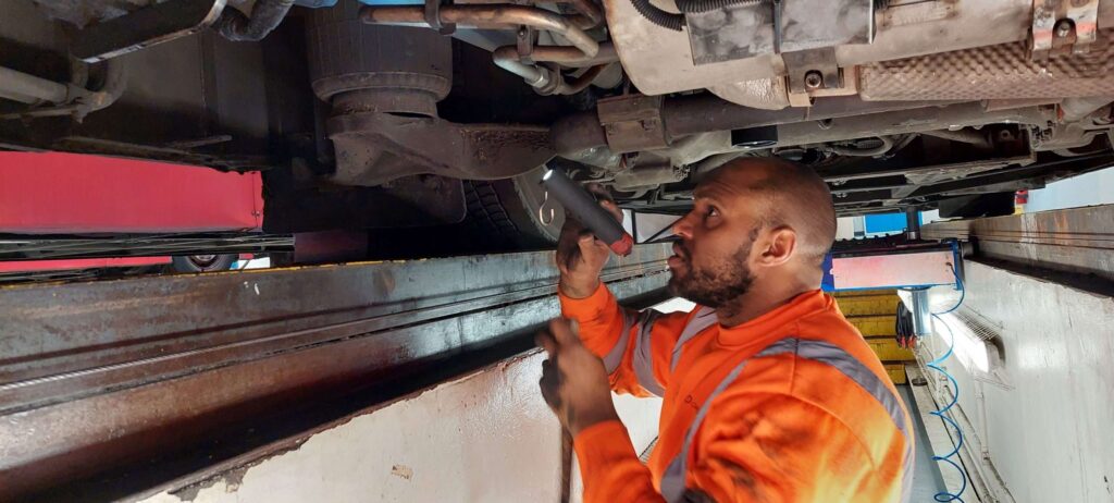 Person inspecting a vehicle